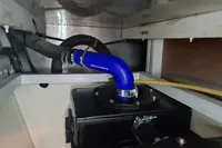 Engine compartment of 2001 Trader 535 Signature with blue hose and black components.