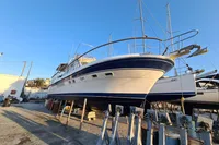 2001 Trader 535 Signature yacht on dry dock under clear blue sky.
