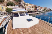 2001 Trader 535 Signature yacht docked by colorful waterfront buildings.