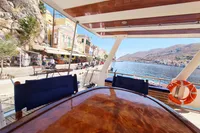 Luxury yacht Trader 535 Signature 2001 docked by scenic waterfront with colorful buildings.