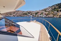 Luxurious 2001 Trader 535 Signature yacht cruising near scenic coastal village.