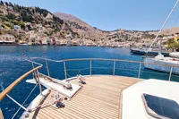 Deck view from 2001 Trader 535 Signature yacht overlooking scenic coastal village and hills.