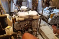 Engine room of a 2001 Trader 535 Signature yacht, showing dual engines and mechanical components.