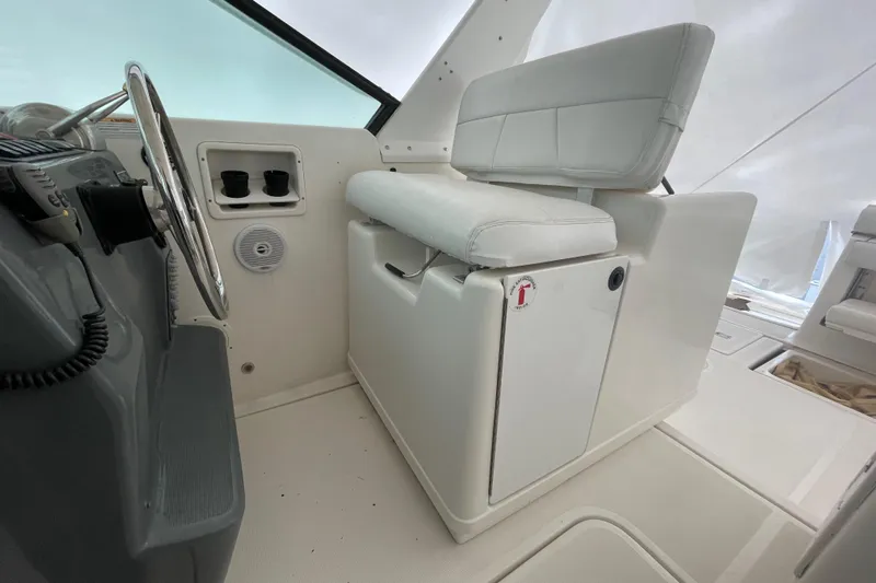  Yacht Photos Pics 2003 Tiara Yachts 3100 Open helm seat and dashboard, featuring white upholstery and steering wheel.