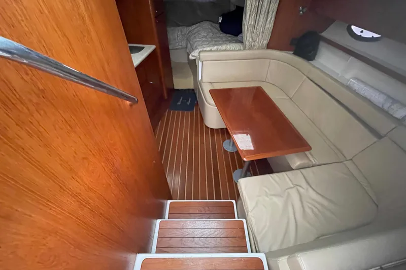  Yacht Photos Pics 2003 Tiara Yachts 3100 Open interior with wooden flooring and beige seating area.