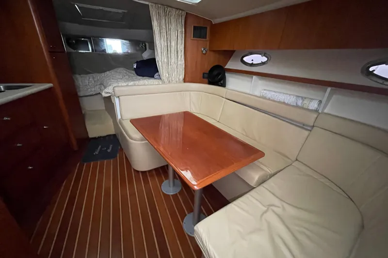  Yacht Photos Pics 2003 Tiara Yachts 3100 Open interior with cozy seating and wooden table.