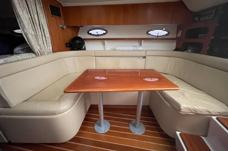  Yacht Photos Pics 2003 Tiara Yachts 3100 Open interior with beige seating and wooden table.