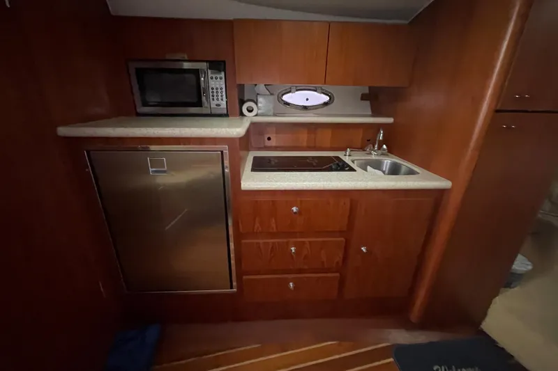  Yacht Photos Pics 2003 Tiara Yachts 3100 Open galley with microwave, sink, and compact fridge.