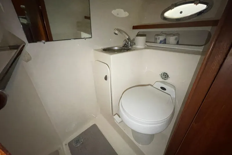  Yacht Photos Pics 2003 Tiara Yachts 3100 Open bathroom with toilet, sink, and mirror.