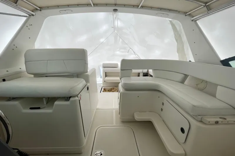  Yacht Photos Pics Interior of a 2003 Tiara Yachts 3100 Open, featuring white seating and helm area.