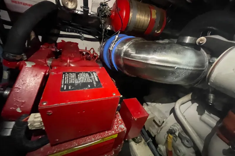  Yacht Photos Pics Engine compartment of a 2003 Tiara Yachts 3100 Open, featuring red machinery and metal components.