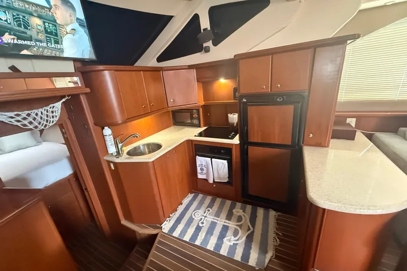  Yacht Photos Pics 2005 Silverton 43 Motor Yacht interior kitchen with wood cabinetry and modern appliances.