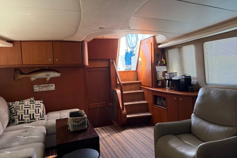  Yacht Photos Pics Luxurious interior of 2005 Silverton 43 Motor Yacht with cozy seating and wooden accents.