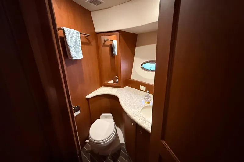  Yacht Photos Pics Luxurious bathroom in 2005 Silverton 43 Motor Yacht with wood accents and modern fixtures.
