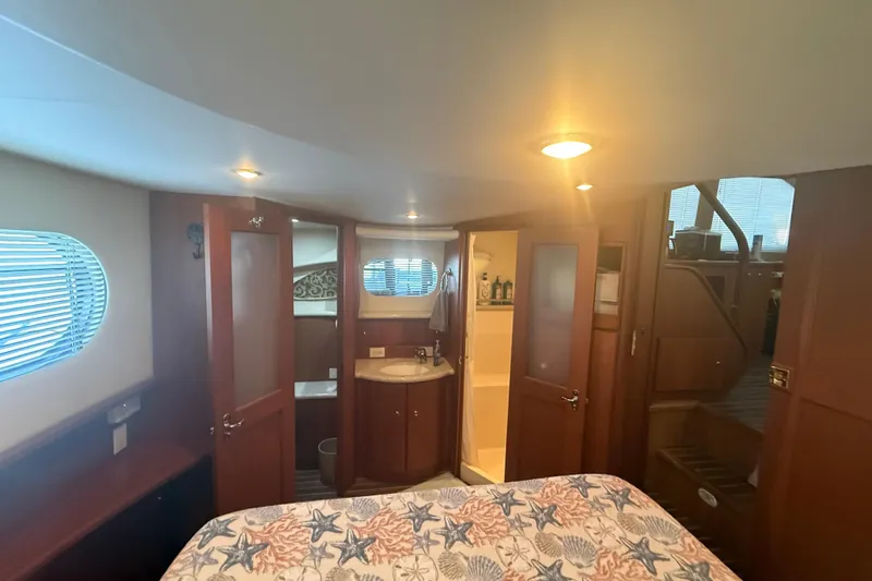  Yacht Photos Pics Luxurious interior of 2005 Silverton 43 Motor Yacht with cozy bedroom and ensuite bathroom.