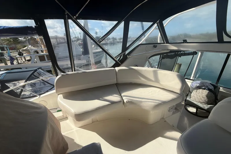  Yacht Photos Pics 2005 Silverton 43 Motor Yacht interior with white seating and marina view.