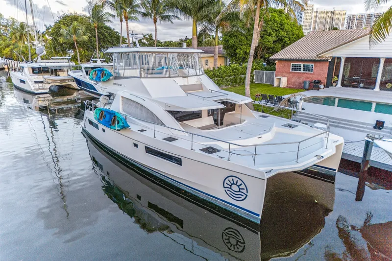 Southern Sky Yacht Photos Pics 2018 Leopard 51 Powercat yacht docked near palm trees and waterfront homes.
