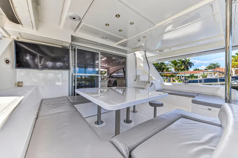Southern Sky Yacht Photos Pics Luxurious interior of 2018 Leopard 51 Powercat yacht with seating, table, and TV.
