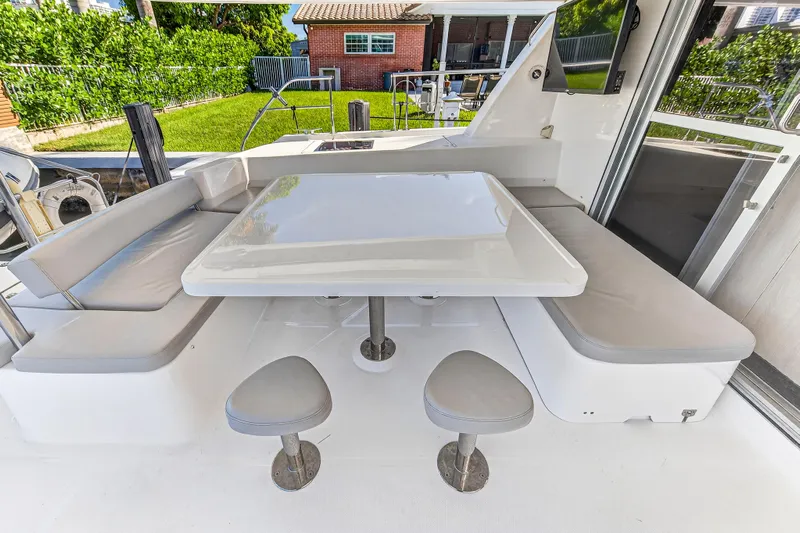 Southern Sky Yacht Photos Pics Outdoor seating area on 2018 Leopard 51 Powercat with cushioned benches and table.