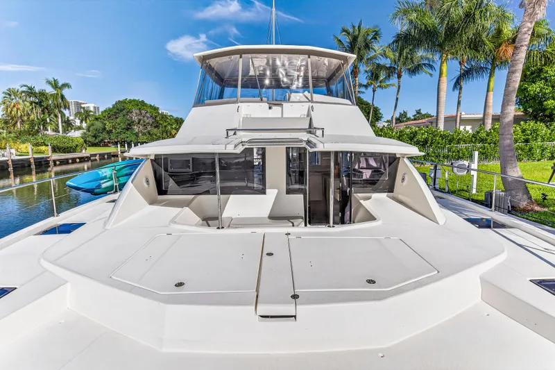 Southern Sky Yacht Photos Pics 2018 Leopard 51 Powercat yacht docked near palm trees, showcasing sleek design and spacious deck.