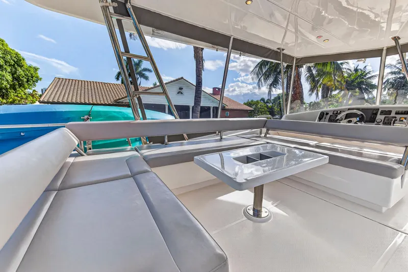 Southern Sky Yacht Photos Pics Luxurious 2018 Leopard 51 Powercat yacht interior with seating and table, surrounded by tropical scenery.