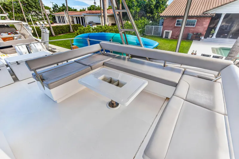 Southern Sky Yacht Photos Pics Outdoor seating area on 2018 Leopard 51 Powercat yacht with cushioned benches and table.