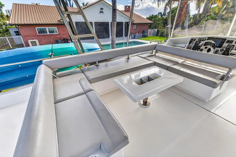 Southern Sky Yacht Photos Pics 2018 Leopard 51 Powercat interior with sleek seating and modern helm, near a poolside view.
