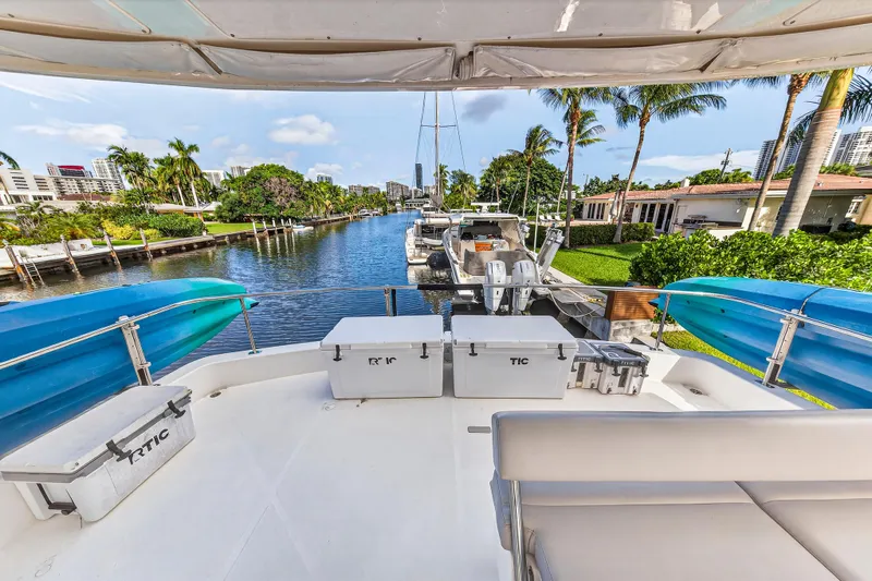 Southern Sky Yacht Photos Pics 2018 Leopard 51 Powercat yacht docked by a scenic canal with palm trees.
