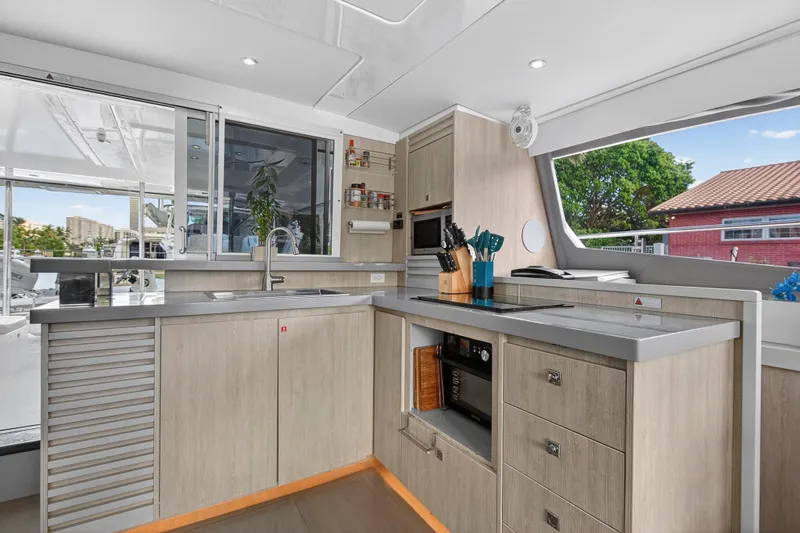 Southern Sky Yacht Photos Pics Modern kitchen interior on 2018 Leopard 51 Powercat yacht, featuring sleek cabinetry and appliances.