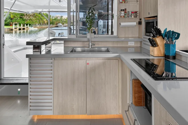 Southern Sky Yacht Photos Pics Modern kitchen interior on 2018 Leopard 51 Powercat yacht, featuring sleek countertops and appliances.