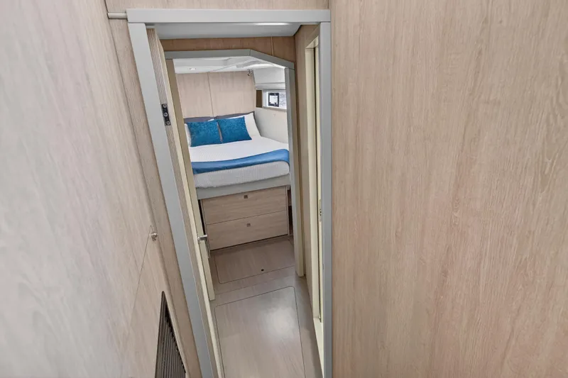 Southern Sky Yacht Photos Pics 2018 Leopard 51 Powercat interior cabin with bed, wooden walls, and modern design.