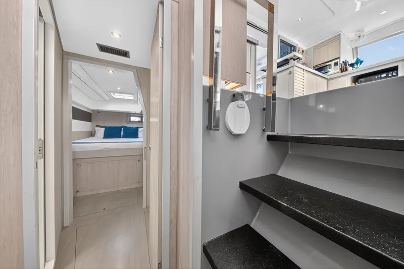 Southern Sky Yacht Photos Pics Interior of 2018 Leopard 51 Powercat, featuring modern bedroom and sleek staircase design.