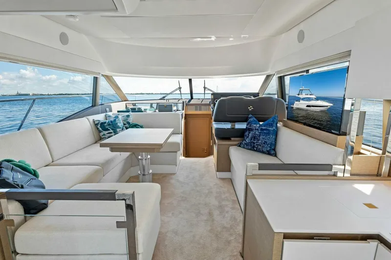 Jilligans Island Yacht Photos Pics Luxurious interior of 2023 Prestige 460 Flybridge yacht with elegant seating and ocean view.