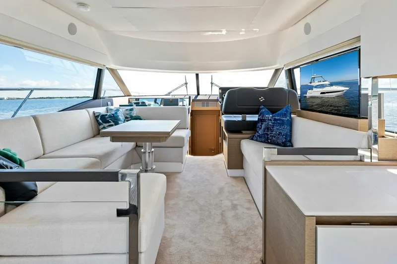 Jilligans Island Yacht Photos Pics Luxurious interior of 2023 Prestige 460 Flybridge yacht with elegant seating and panoramic windows.