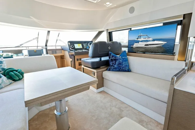 Jilligans Island Yacht Photos Pics Luxurious interior of 2023 Prestige 460 Flybridge yacht with modern seating and navigation area.