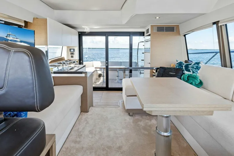 Jilligans Island Yacht Photos Pics Luxurious interior of 2023 Prestige 460 Flybridge yacht with ocean view.