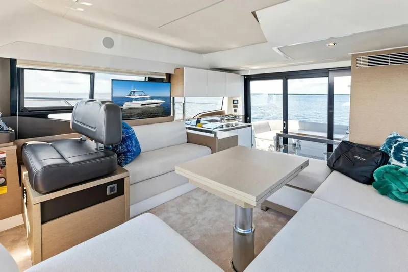 Jilligans Island Yacht Photos Pics Luxurious interior of 2023 Prestige 460 Flybridge yacht with modern furnishings and ocean view.