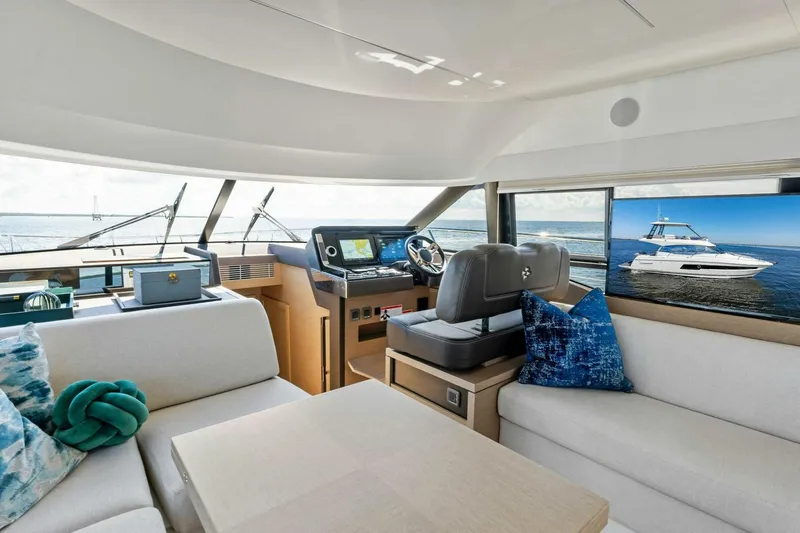Jilligans Island Yacht Photos Pics Luxurious interior of 2023 Prestige 460 Flybridge yacht with modern helm and seating.