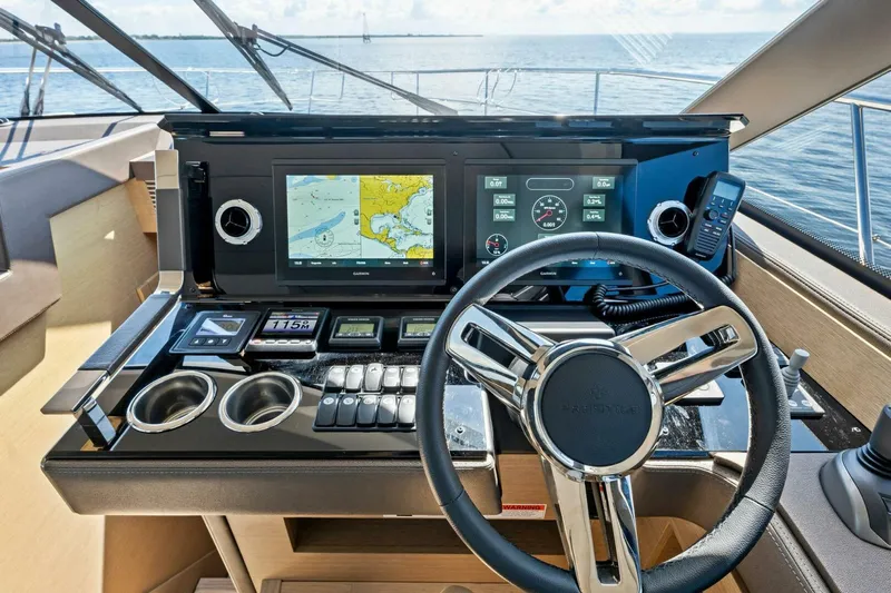 Jilligans Island Yacht Photos Pics Prestige 460 Flybridge 2023 helm with navigation screens and controls, overlooking the ocean.