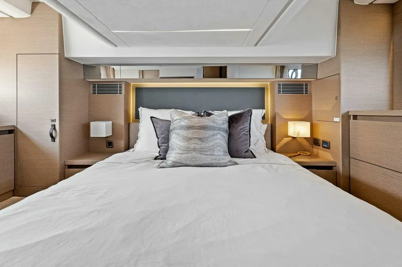 Jilligans Island Yacht Photos Pics Luxurious bedroom interior of 2023 Prestige 460 Flybridge yacht with modern design.