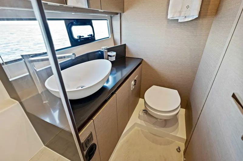 Jilligans Island Yacht Photos Pics Luxurious bathroom in 2023 Prestige 460 Flybridge yacht with modern sink and toilet.
