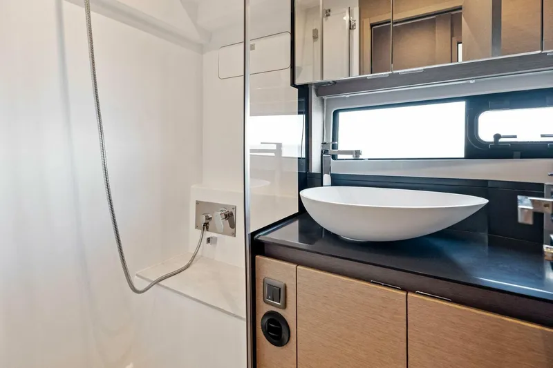 Jilligans Island Yacht Photos Pics Modern bathroom in 2023 Prestige 460 Flybridge yacht with sleek sink and shower.