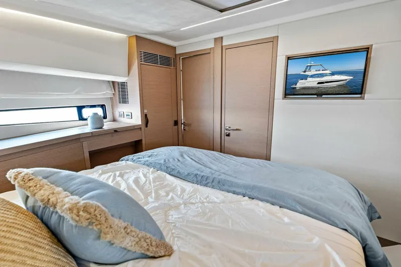 Jilligans Island Yacht Photos Pics Luxurious bedroom interior of 2023 Prestige 460 Flybridge yacht with modern decor.
