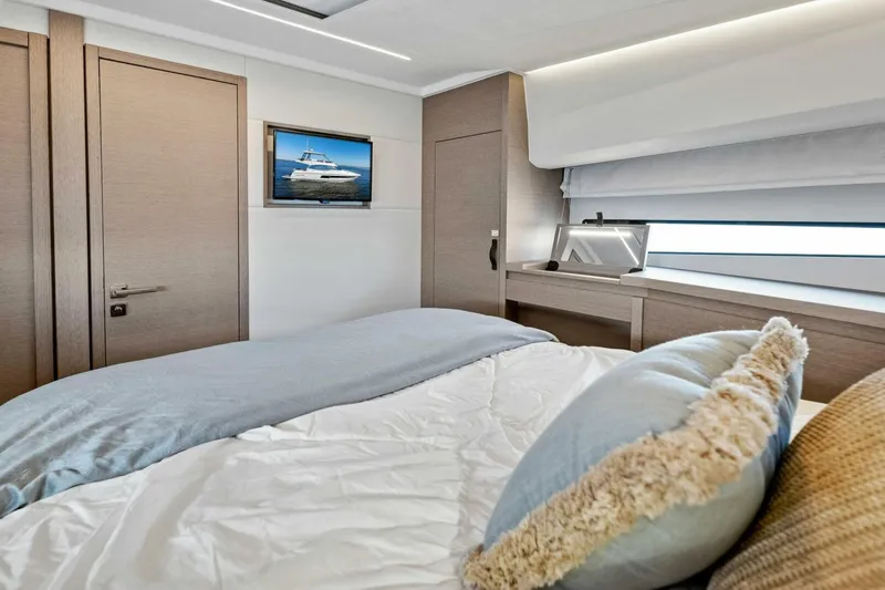 Jilligans Island Yacht Photos Pics Luxurious bedroom interior of 2023 Prestige 460 Flybridge yacht with modern decor.