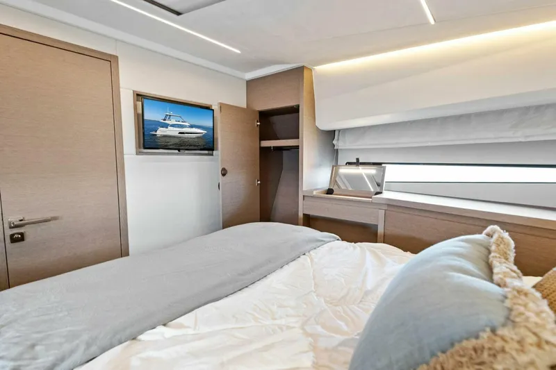 Jilligans Island Yacht Photos Pics Luxurious bedroom interior of 2023 Prestige 460 Flybridge yacht with modern decor.