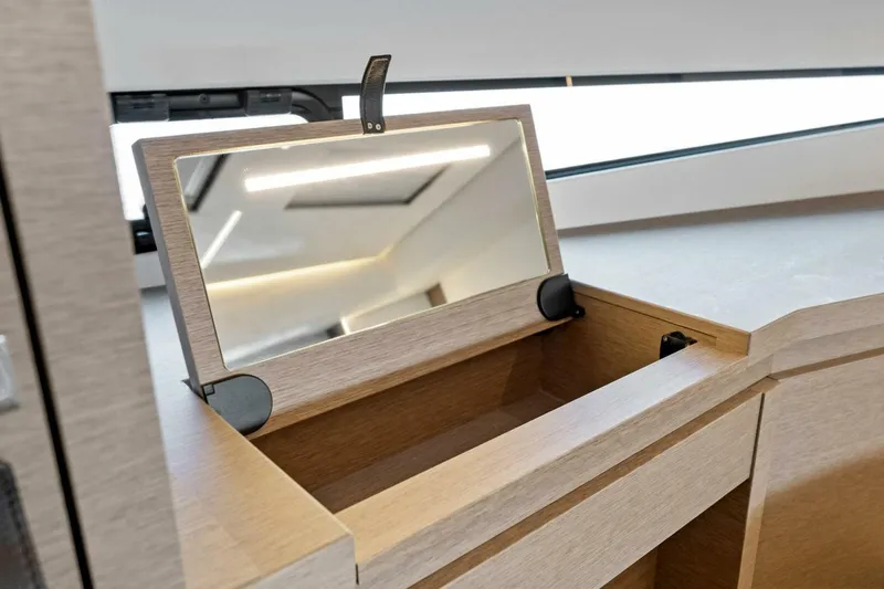 Jilligans Island Yacht Photos Pics Prestige 460 Flybridge 2023 interior with open vanity mirror and storage compartment.