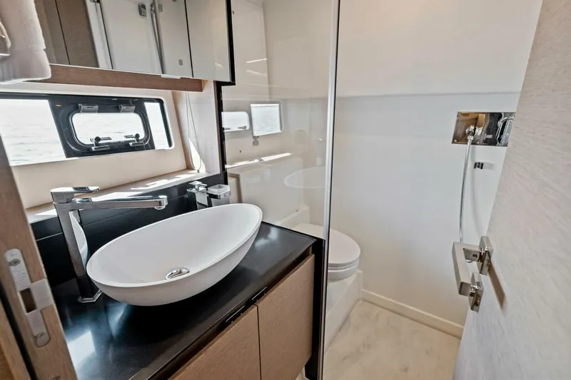 Jilligans Island Yacht Photos Pics Luxurious bathroom in 2023 Prestige 460 Flybridge yacht with modern fixtures and sleek design.