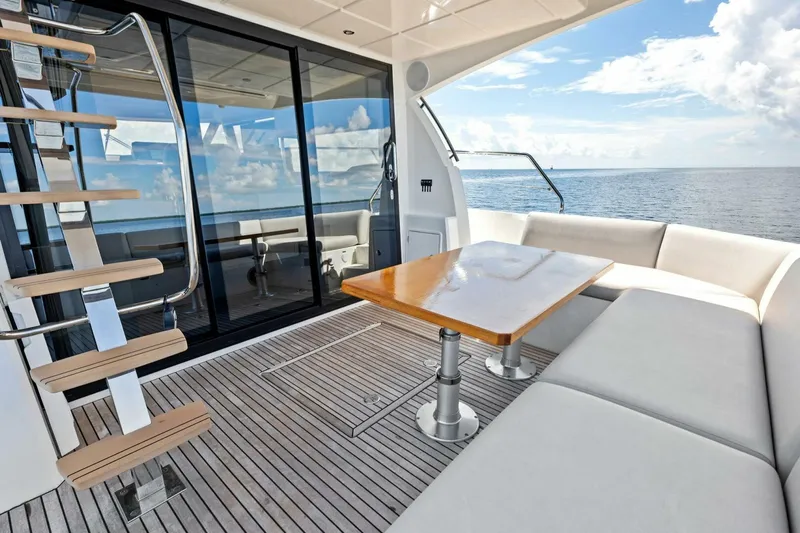 Jilligans Island Yacht Photos Pics Luxurious 2023 Prestige 460 Flybridge yacht with elegant seating and ocean view.