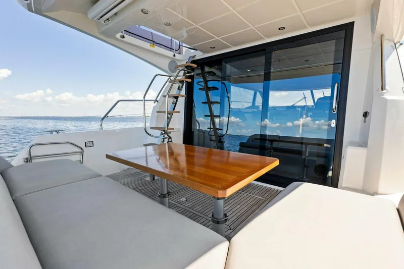 Jilligans Island Yacht Photos Pics Prestige 460 Flybridge 2023 yacht with elegant outdoor seating and ocean view.