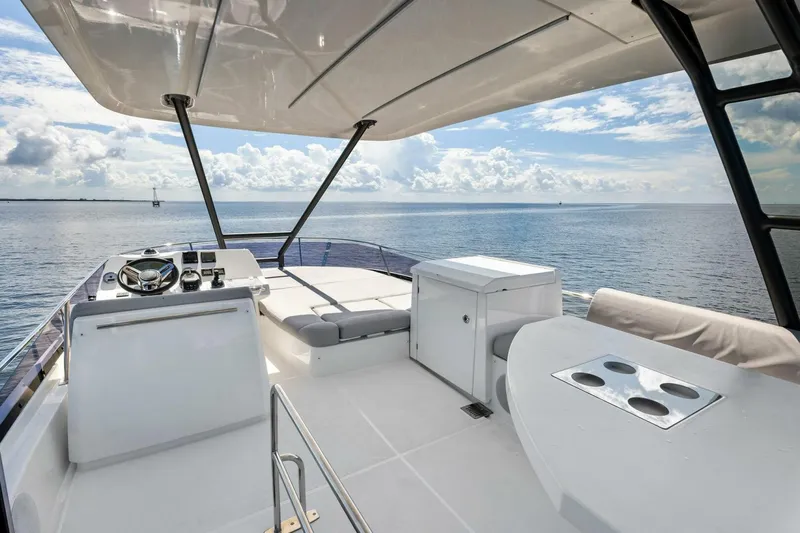Jilligans Island Yacht Photos Pics 2023 Prestige 460 Flybridge yacht with spacious deck and ocean view.